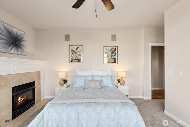 bedroom featuring visible vents, carpet floors, a fireplace, baseboards, and ceiling fan