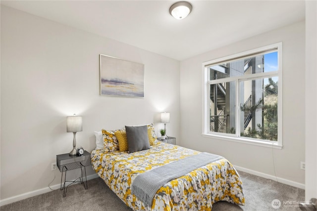 carpeted bedroom with multiple windows and baseboards