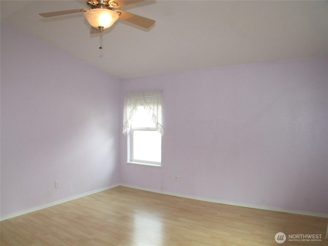 unfurnished room featuring a ceiling fan, baseboards, and light wood-style floors