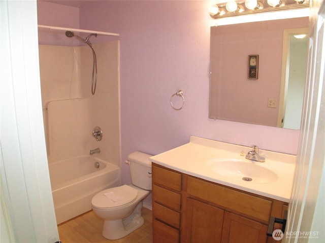 bathroom with toilet, shower / bathing tub combination, vanity, and wood finished floors