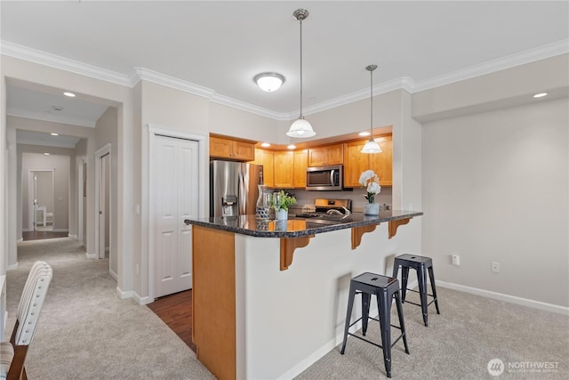 kitchen with crown molding, light colored carpet, a breakfast bar, appliances with stainless steel finishes, and a peninsula