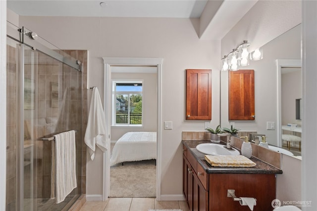 full bath with vanity, baseboards, a shower stall, tile patterned floors, and connected bathroom