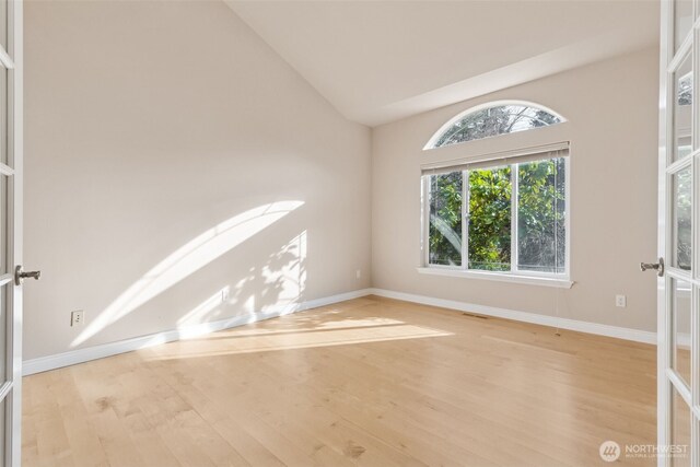 6719 Prairie Ridge Dr NE, Olympia, WA 98516 - unfurnished room featuring visible vents, lofted ceiling, baseboards, and wood finished floors