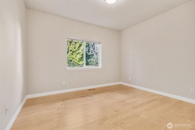 6719 Prairie Ridge Dr NE, Olympia, WA 98516 - spare room featuring baseboards and light wood finished floors