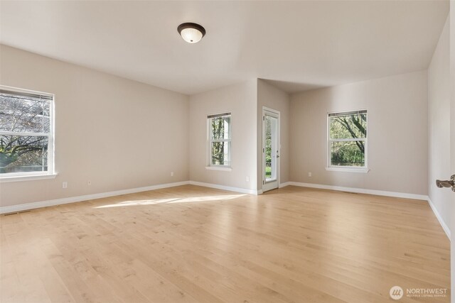 6719 Prairie Ridge Dr NE, Olympia, WA 98516 - empty room featuring visible vents, baseboards, and light wood-type flooring