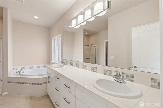 6719 Prairie Ridge Dr NE, Olympia, WA 98516 - full bath featuring a sink, a garden tub, a stall shower, and tile patterned floors
