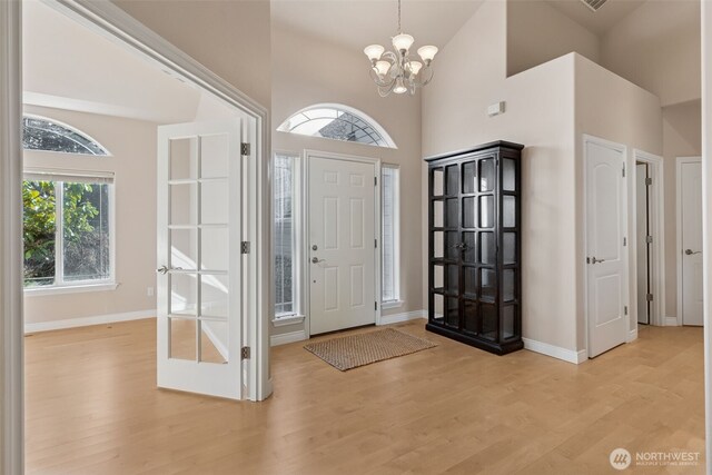 6719 Prairie Ridge Dr NE, Olympia, WA 98516 - foyer entrance with a notable chandelier, plenty of natural light, light wood-style floors, and baseboards