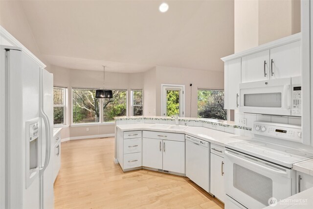 6719 Prairie Ridge Dr NE, Olympia, WA 98516 - kitchen featuring a sink, white appliances, a peninsula, white cabinets, and light wood finished floors