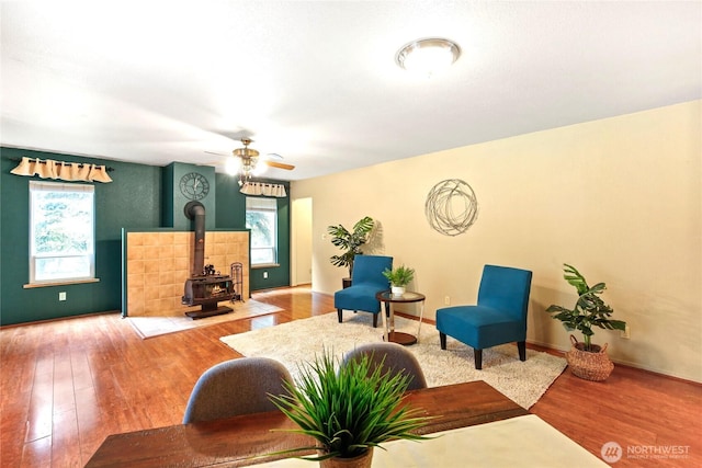 3348 SW Christmas Tree Ln, Port Orchard, WA 98367 - living area with wood finished floors, a wood stove, and a ceiling fan