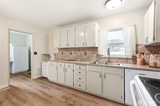 3348 SW Christmas Tree Ln, Port Orchard, WA 98367 - kitchen with freestanding refrigerator, range, tasteful backsplash, light countertops, and light wood-style floors