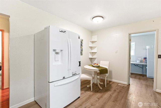 3348 SW Christmas Tree Ln, Port Orchard, WA 98367 - kitchen featuring white fridge with ice dispenser and light wood-type flooring