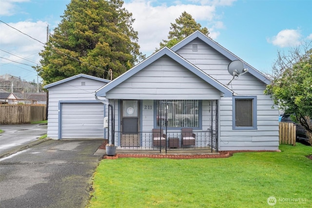 211 30th St, Hoquiam, WA 98550 - bungalow featuring fence, a front yard, covered porch, a garage, and driveway