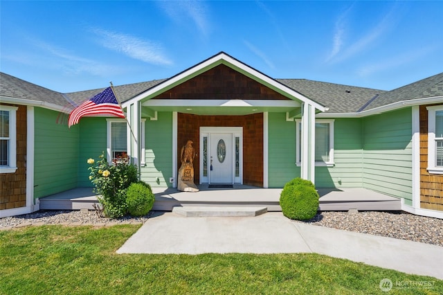 502 County Road 448, Walla Walla, WA 99362 - view of exterior entry with a porch, roof with shingles, and a lawn