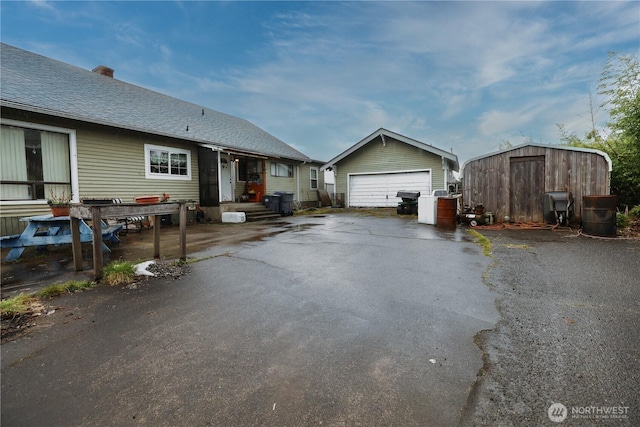 55 Devonshire Rd, Montesano, WA 98563 - view of home's exterior with a detached garage and a chimney