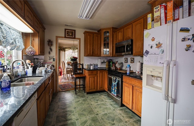 55 Devonshire Rd, Montesano, WA 98563 - kitchen with appliances with stainless steel finishes, a sink, glass insert cabinets, brown cabinets, and dark stone counters