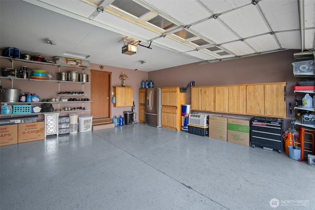 6473 Trigg Woods Ln, Ferndale, WA 98248 - garage with stainless steel fridge and a garage door opener
