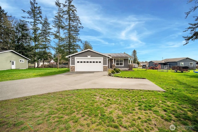 6473 Trigg Woods Ln, Ferndale, WA 98248 - single story home featuring solar panels, a front lawn, a garage, stone siding, and driveway