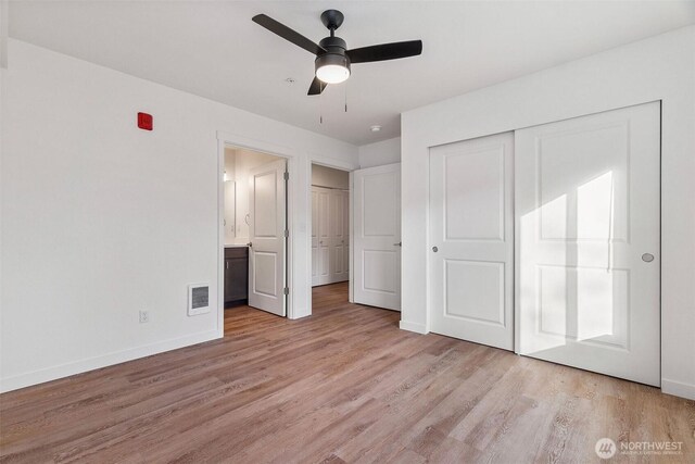 20107 Blair Ln, Rochester, WA 98579 - unfurnished bedroom with visible vents, baseboards, ensuite bath, light wood-style floors, and a closet