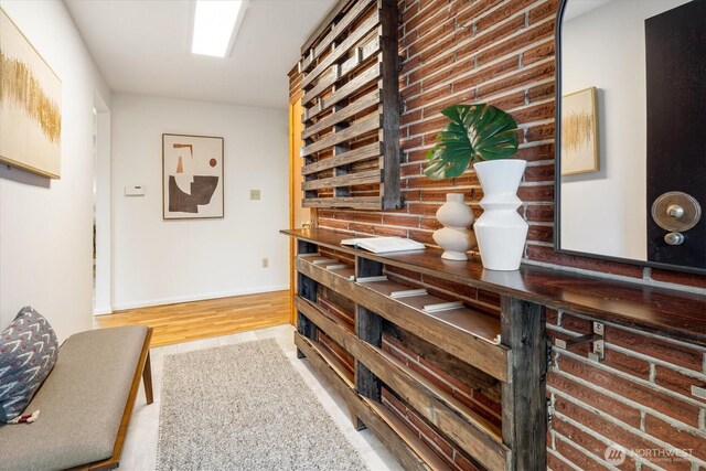 hallway featuring baseboards and wood finished floors