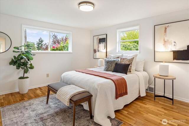 bedroom with light wood-type flooring and baseboards
