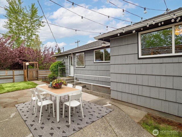view of patio with fence and outdoor dining space