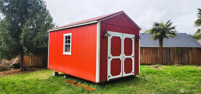 view of shed with fence