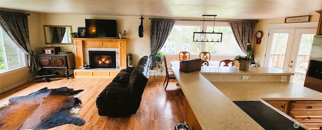 living area featuring a tiled fireplace and wood finished floors