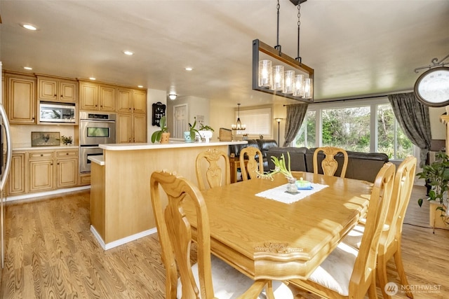 dining area with light wood-style flooring and recessed lighting
