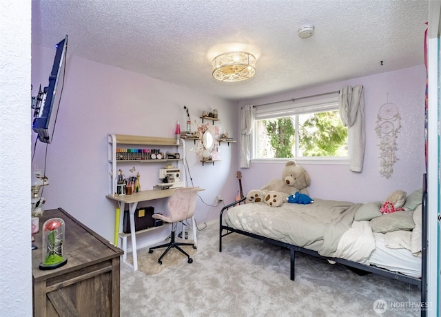bedroom featuring carpet floors and a textured ceiling