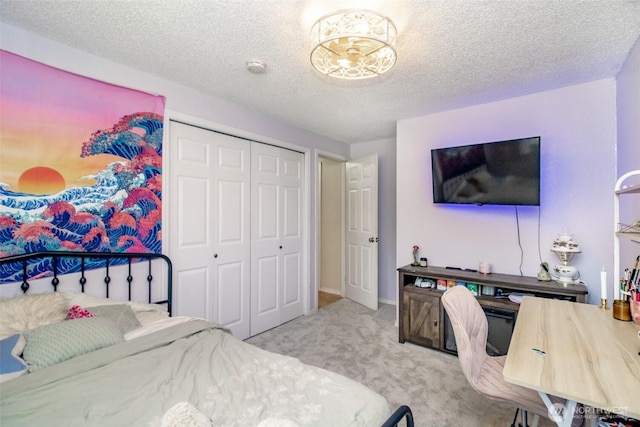 carpeted bedroom featuring a closet and a textured ceiling