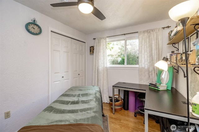 bedroom featuring a closet, ceiling fan, and wood finished floors
