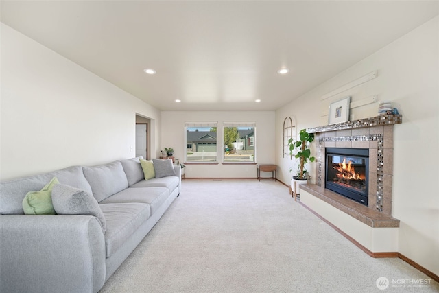 living area with recessed lighting, baseboards, carpet floors, and a tiled fireplace