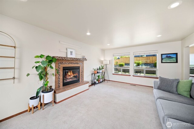 living area with recessed lighting, carpet flooring, baseboards, and a tile fireplace