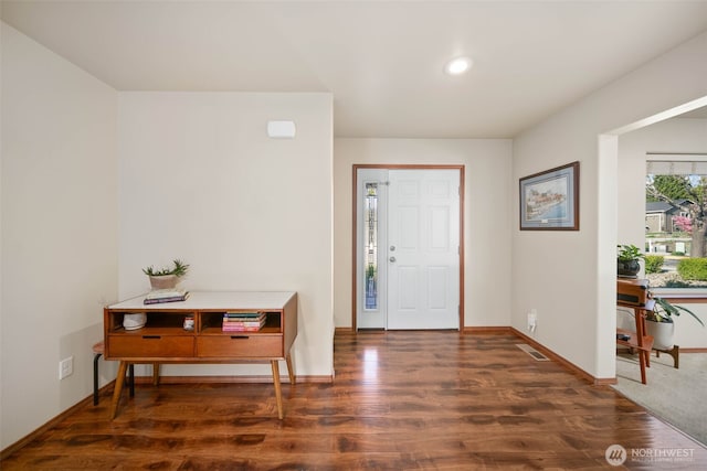 foyer entrance with baseboards, recessed lighting, wood finished floors, and visible vents