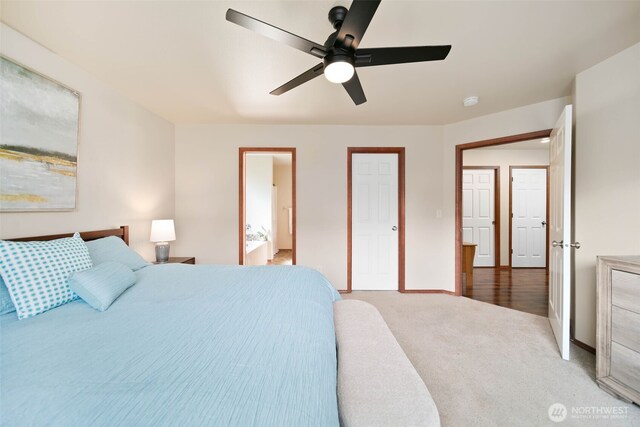 bedroom featuring connected bathroom, baseboards, ceiling fan, and carpet