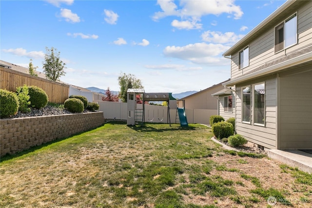 view of yard with a playground and a fenced backyard