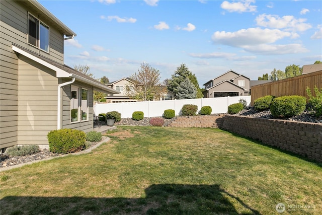 view of yard with a fenced backyard