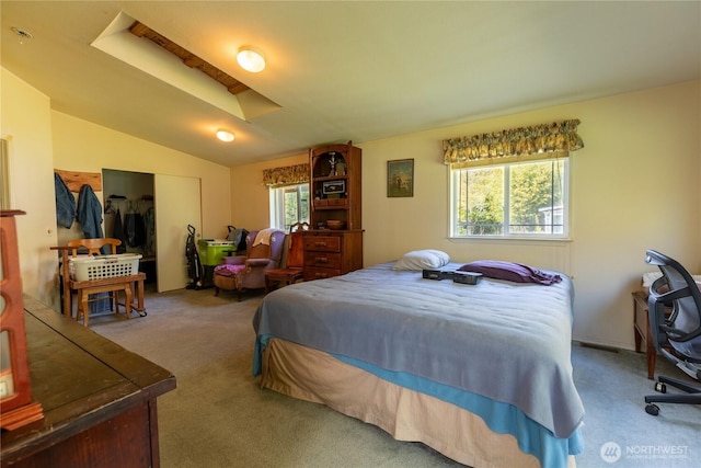 carpeted bedroom with lofted ceiling