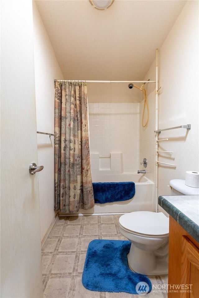 bathroom featuring toilet, tile patterned floors, vanity, and shower / tub combo