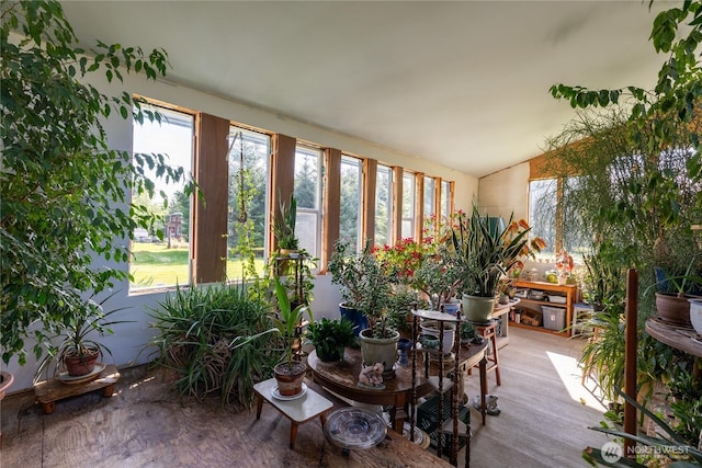 sunroom with vaulted ceiling and a healthy amount of sunlight