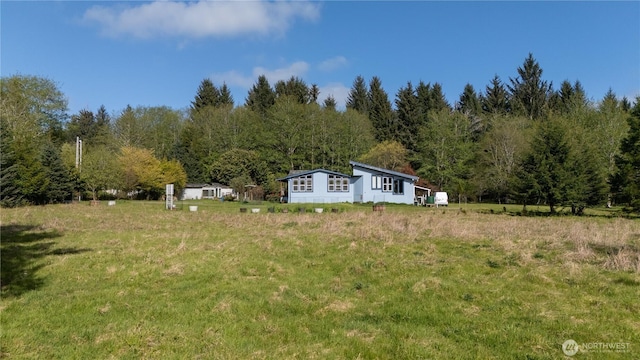 view of yard with a view of trees
