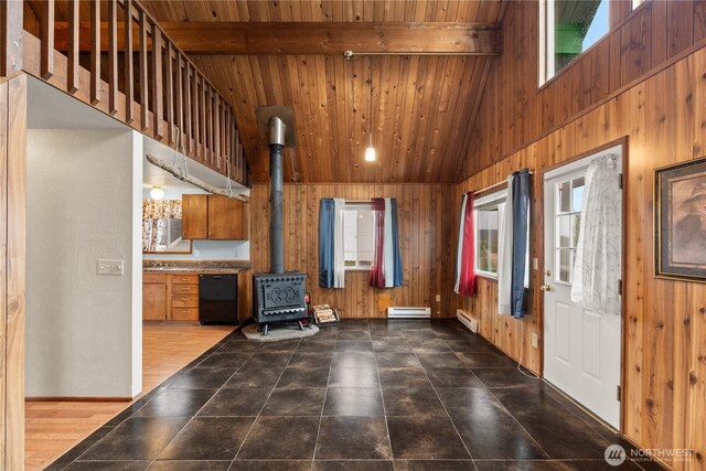 1205 Fairwood Dr SW, Ocean Shores, WA 98569 - interior space with beam ceiling, wood walls, and a wood stove