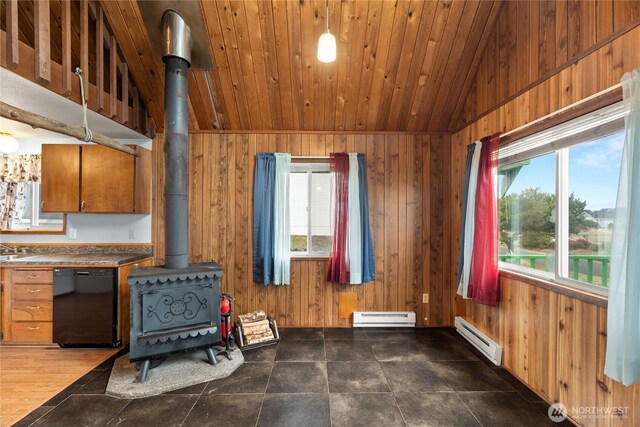 1205 Fairwood Dr SW, Ocean Shores, WA 98569 - kitchen with black dishwasher, baseboard heating, wood walls, and a wood stove
