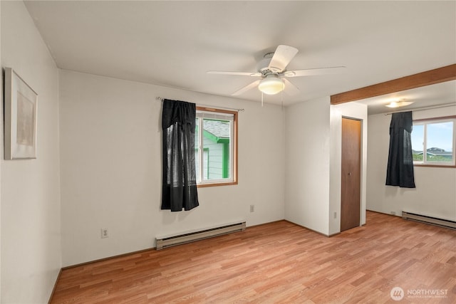 1205 Fairwood Dr SW, Ocean Shores, WA 98569 - spare room featuring light wood-type flooring, a baseboard heating unit, and ceiling fan