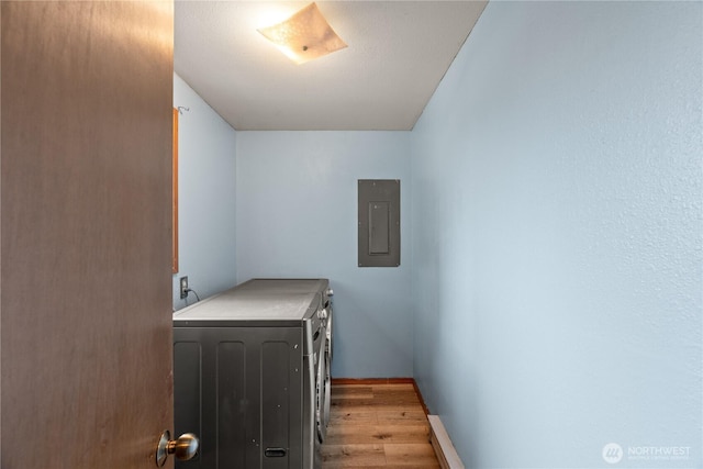1205 Fairwood Dr SW, Ocean Shores, WA 98569 - laundry area featuring washing machine and clothes dryer, baseboards, electric panel, laundry area, and light wood-style floors