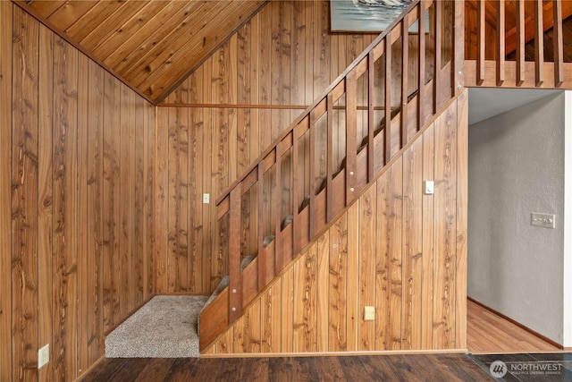 1205 Fairwood Dr SW, Ocean Shores, WA 98569 - stairway featuring lofted ceiling, wooden walls, and wood finished floors