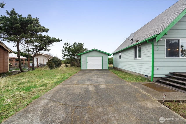 1205 Fairwood Dr SW, Ocean Shores, WA 98569 - view of home's exterior featuring an outdoor structure, a garage, driveway, and crawl space