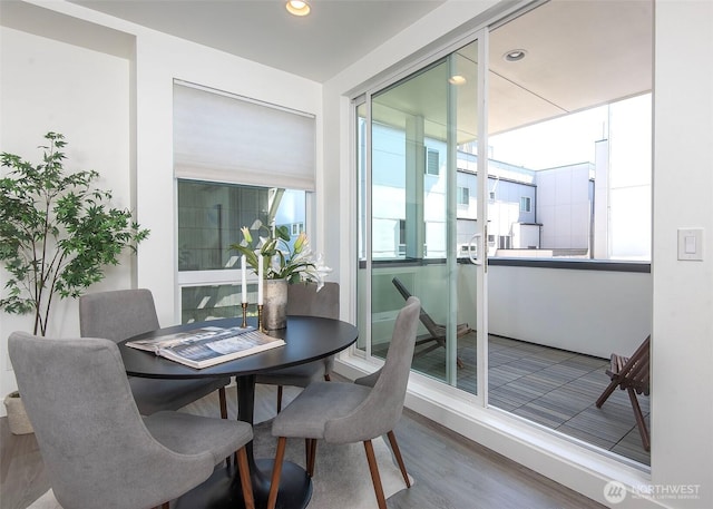dining space with recessed lighting and wood finished floors