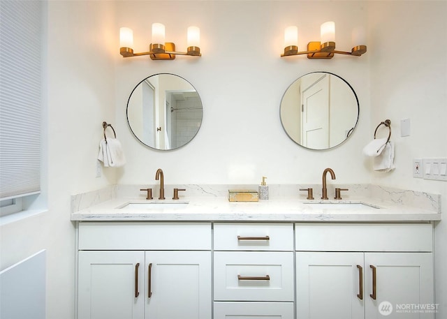 full bathroom featuring double vanity and a sink