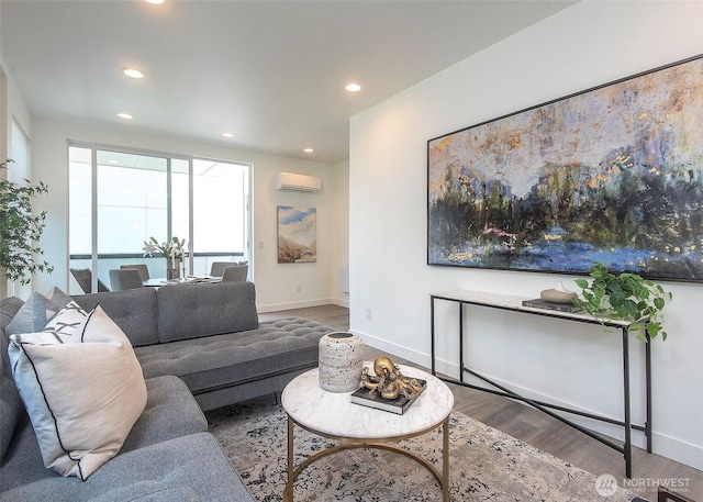 living area with recessed lighting, baseboards, a wall unit AC, and wood finished floors